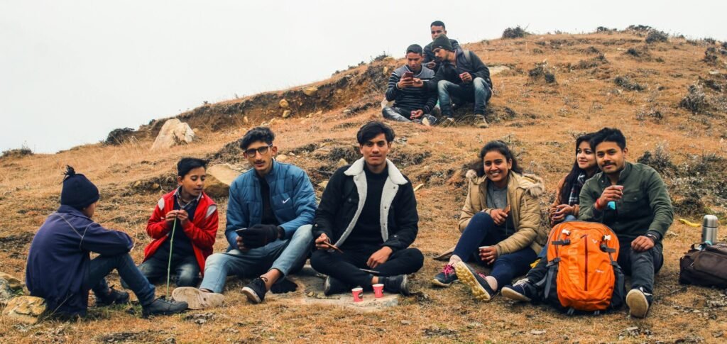 College Trips in India: Creating Memorable Student Travel Experiences A group of friends relaxing on a scenic hilltop in Malkhi, India, enjoying nature.